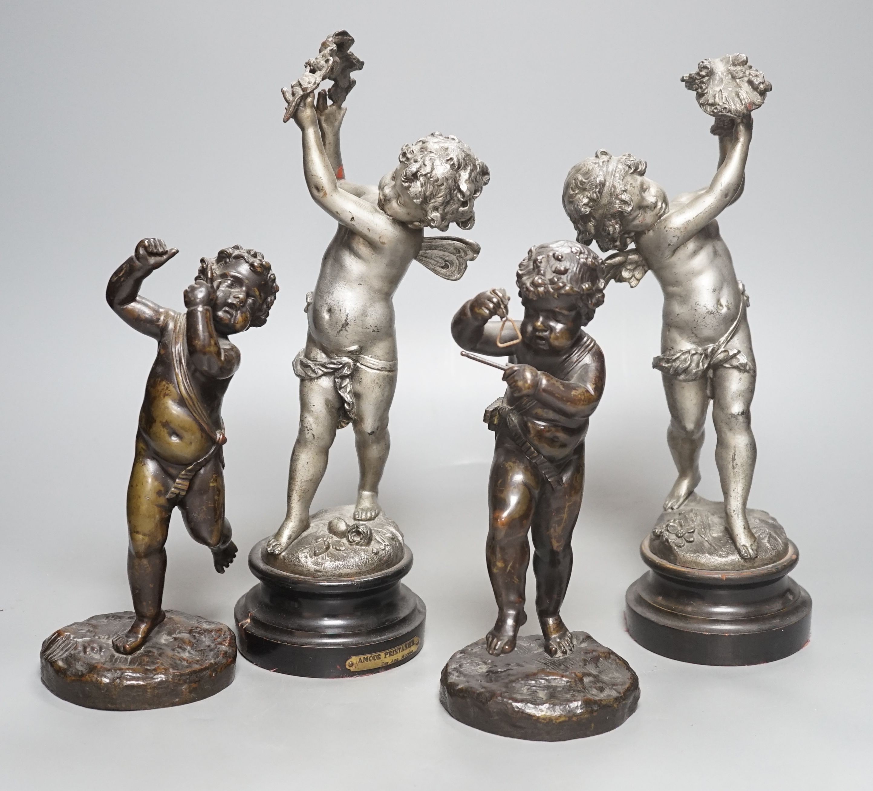 A pair of bronze musical putti and a pair of seasonal spelter putti - tallest 32cm